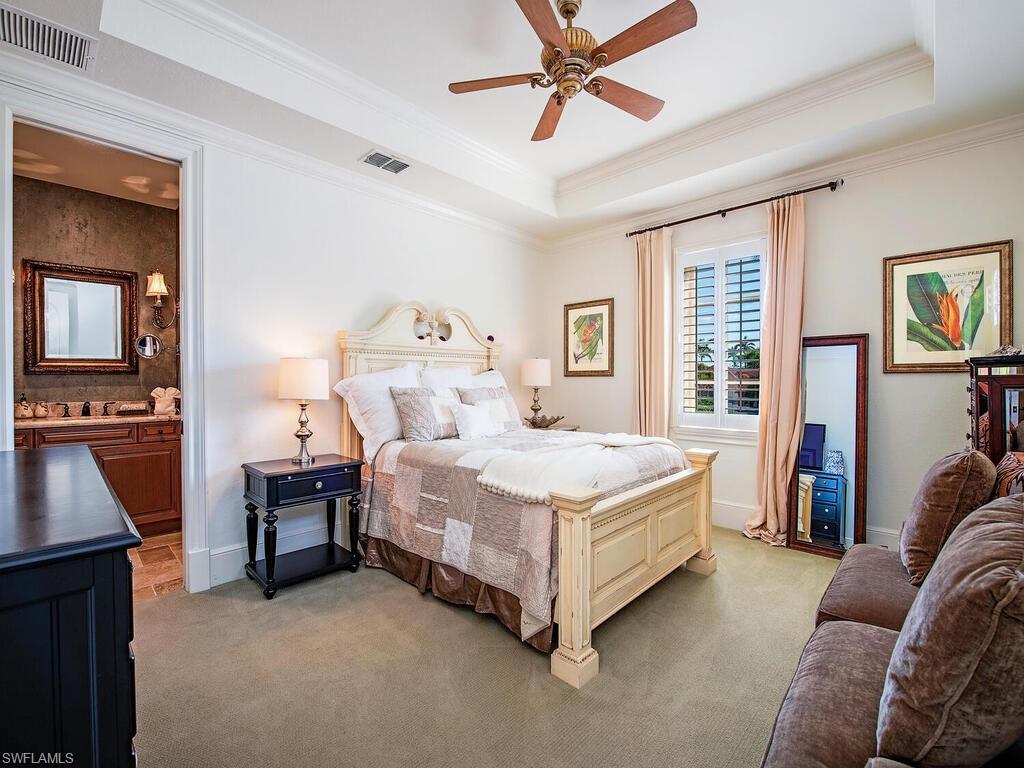 155 20th Avenue South Naples, FL 34102 - Photo 12 of 30 Carpeted bedroom with a raised ceiling, crown molding, ceiling fan, and ensuite bathroom