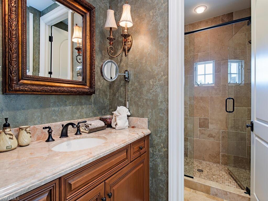 155 20th Avenue South Naples, FL 34102 - Photo 13 of 30 Bathroom with a shower stall and vanity