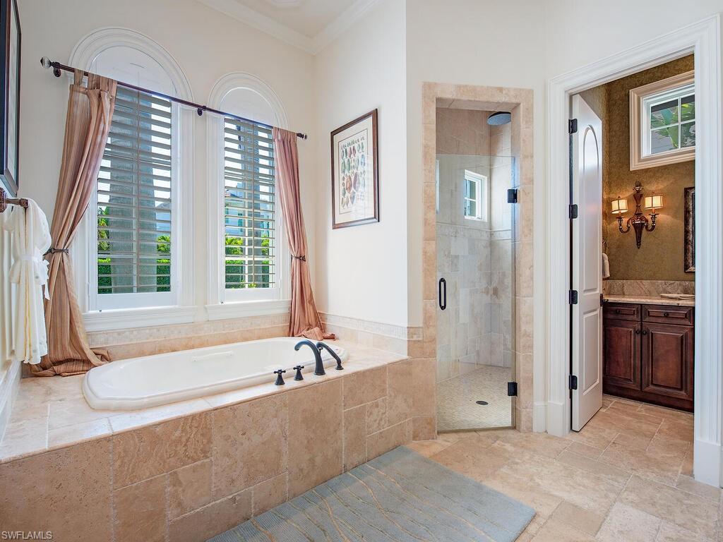 155 20th Avenue South Naples, FL 34102 - Photo 19 of 30 Full bath with a stall shower, healthy amount of natural light, vanity, a garden tub, and ornamental molding