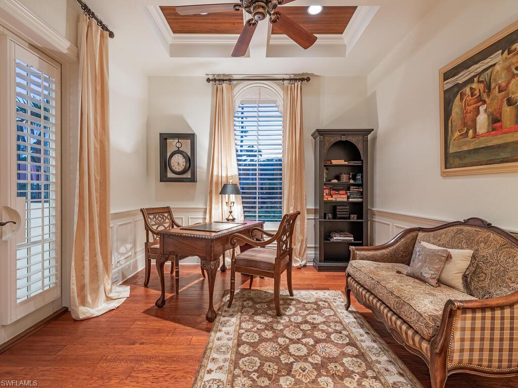 155 20th Avenue South Naples, FL 34102 - Photo 22 of 30 Office area featuring light wood-style flooring, ornamental molding, a ceiling fan, wainscoting, and a raised ceiling