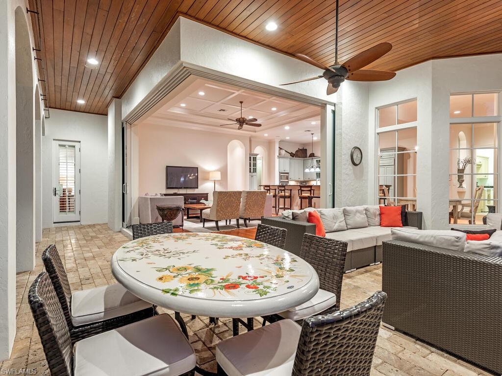 155 20th Avenue South Naples, FL 34102 - Photo 26 of 30 Dining room featuring arched walkways, wood ceiling, recessed lighting, ceiling fan, and stone tile floors