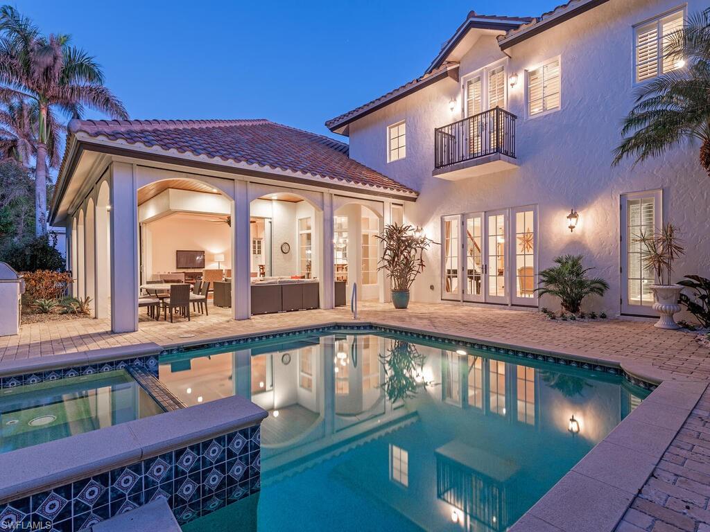 155 20th Avenue South Naples, FL 34102 - Photo 27 of 30 View of swimming pool with french doors, a patio, a balcony, and a pool with connected hot tub