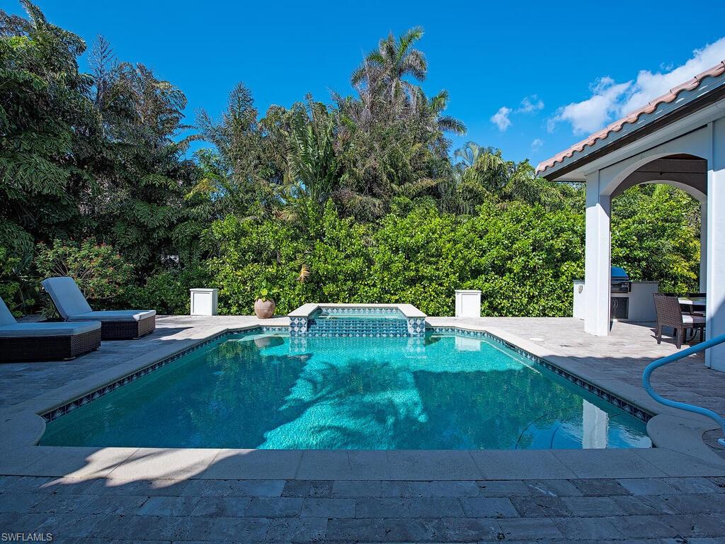 155 20th Avenue South Naples, FL 34102 - Photo 4 of 30 View of pool with a patio, a pool with connected hot tub, and exterior kitchen