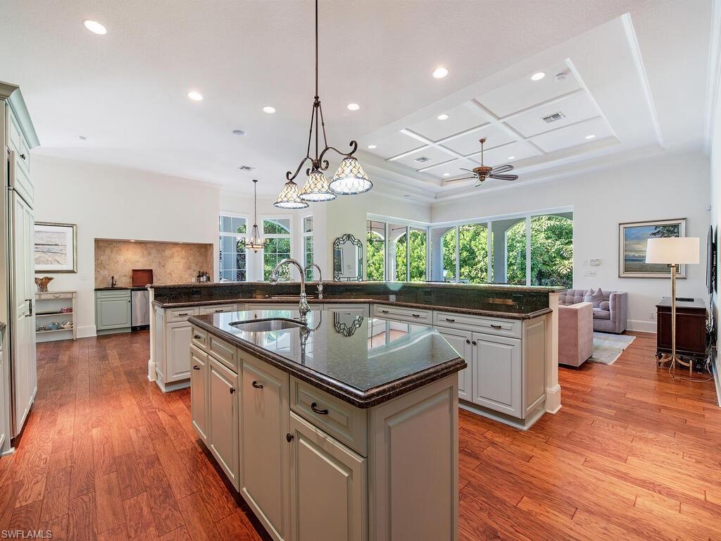 155 20th Avenue South Naples, FL 34102 - Photo 30 of 30 Kitchen featuring open floor plan, dark stone counters, recessed lighting, pendant lighting, and light wood-type flooring