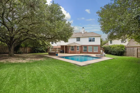 a view of a house with a backyard