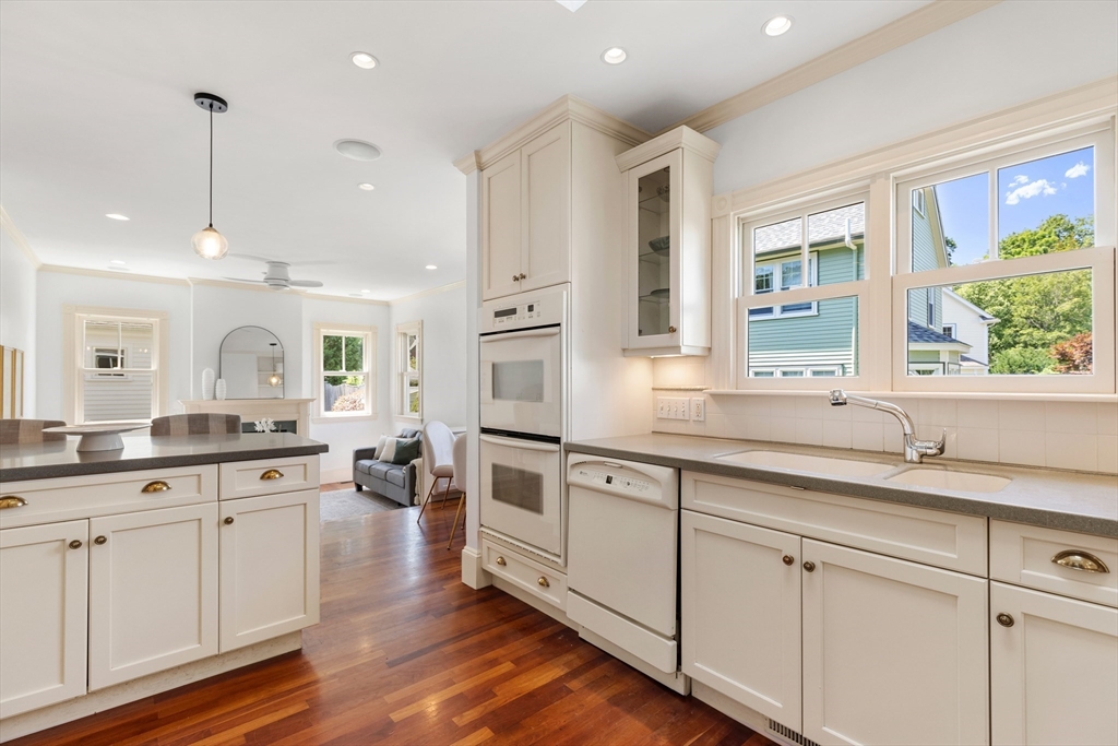 8 Jackson Court Lexington, MA 02421 - Photo 11 of 27 a large kitchen with granite countertop lots of white cabinets and wooden floor