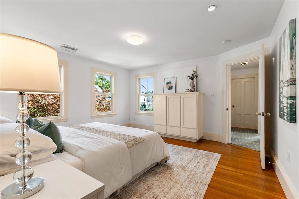 8 Jackson Court Lexington, MA 02421 - Photo 18 of 27 a spacious bedroom with a bed and wooden floor