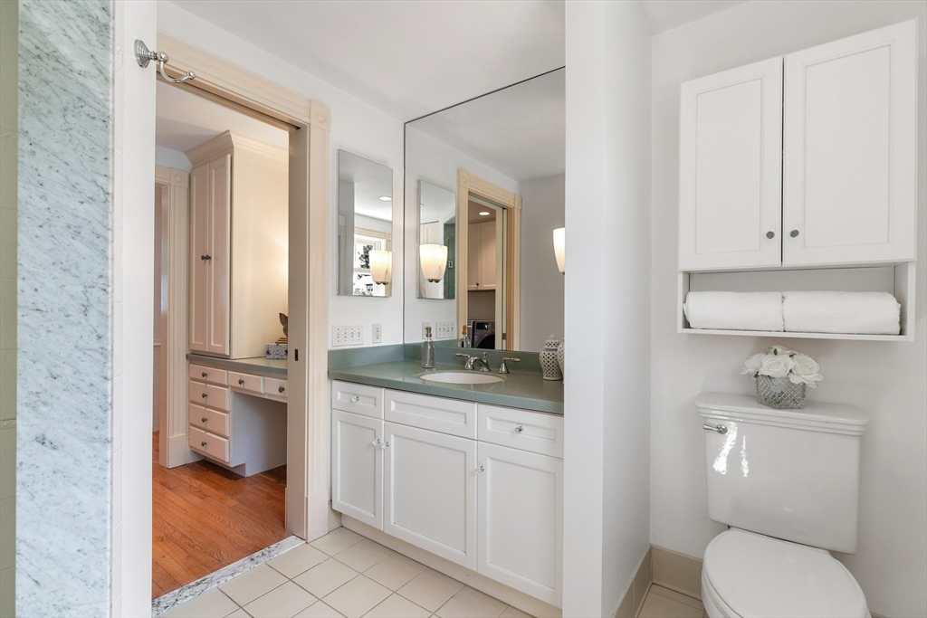 8 Jackson Court Lexington, MA 02421 - Photo 20 of 27 a bathroom with a granite countertop toilet sink and mirror