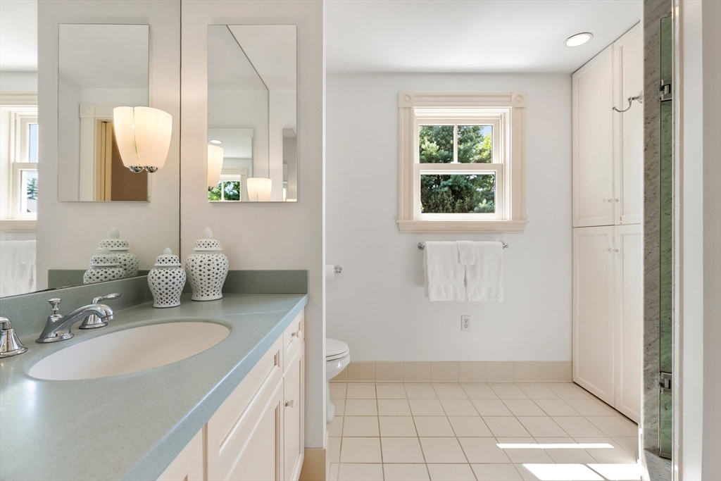 8 Jackson Court Lexington, MA 02421 - Photo 21 of 27 a bathroom with a granite countertop sink and a mirror