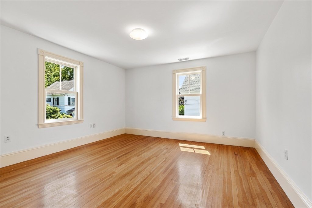8 Jackson Court Lexington, MA 02421 - Photo 22 of 27 an empty room with wooden floor and windows
