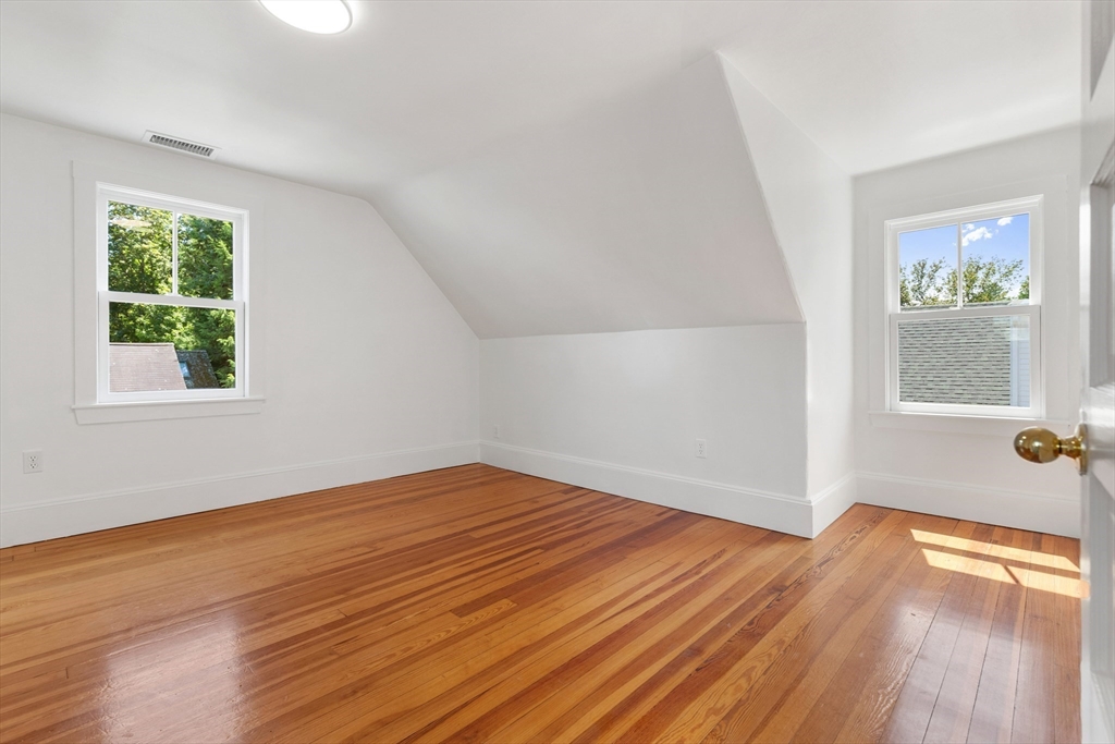 8 Jackson Court Lexington, MA 02421 - Photo 23 of 27 an empty room with wooden floor and windows
