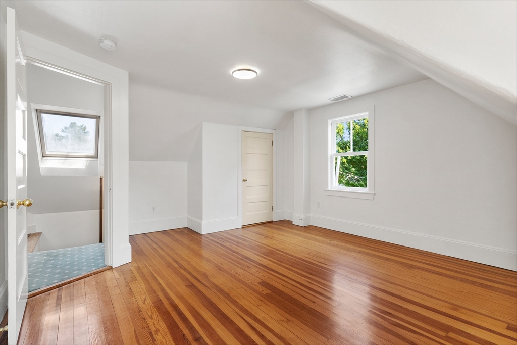 8 Jackson Court Lexington, MA 02421 - Photo 26 of 27 a view of an empty room with wooden floor and a window