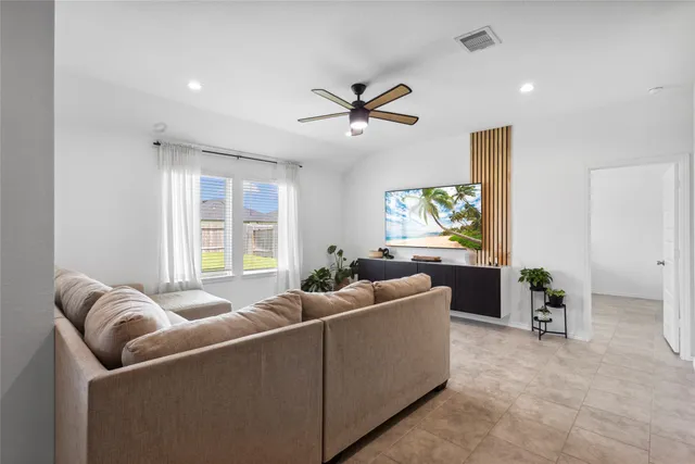 a living room with furniture and windows
