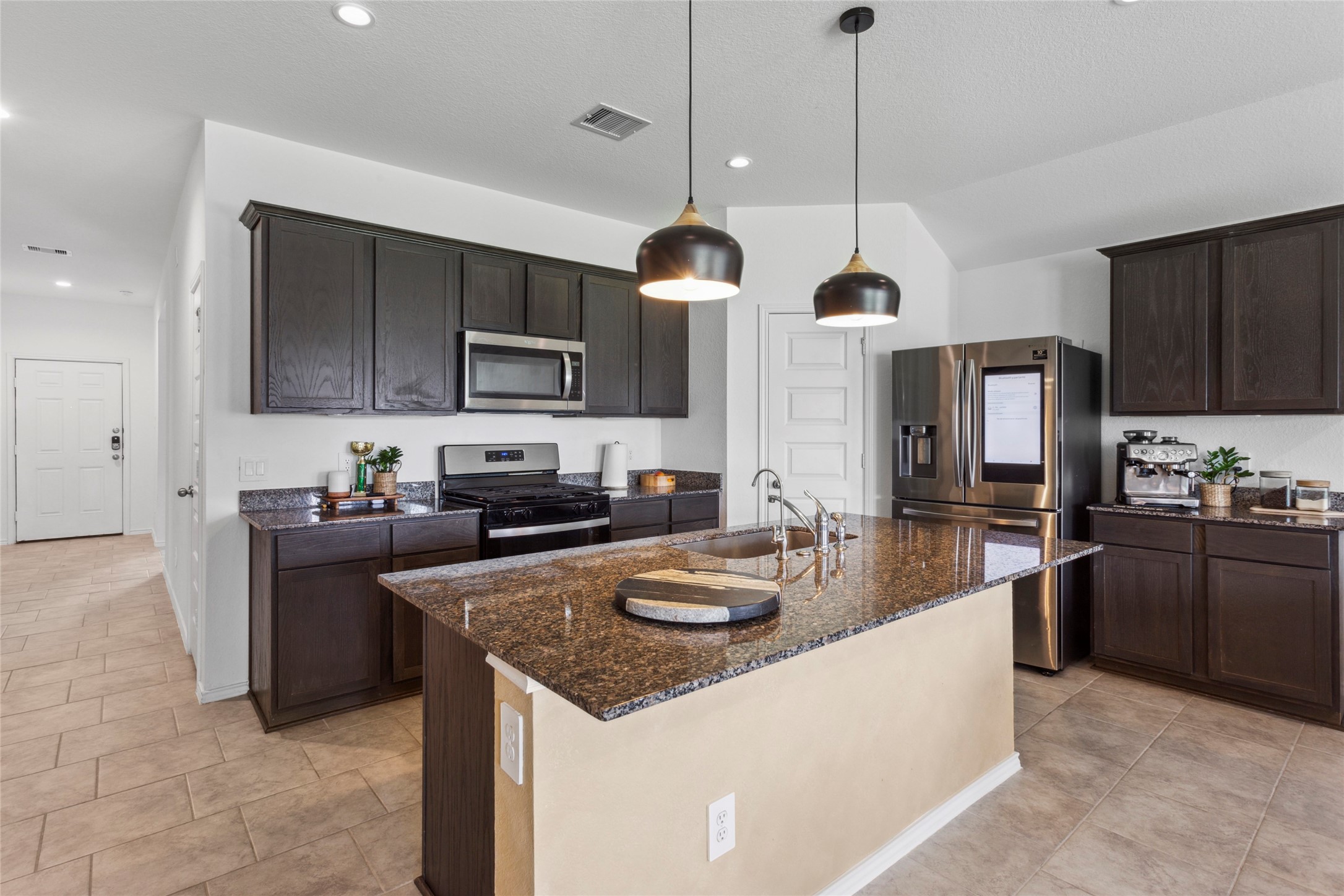 7510 Carson Court Rosharon, TX 77583 - Photo 5 of 23 a kitchen with granite countertop stainless steel appliances and wooden cabinets