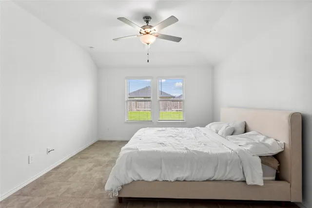 a bedroom with a bed and window