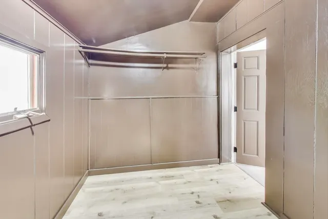 a view of a room with rack on the wall and a window