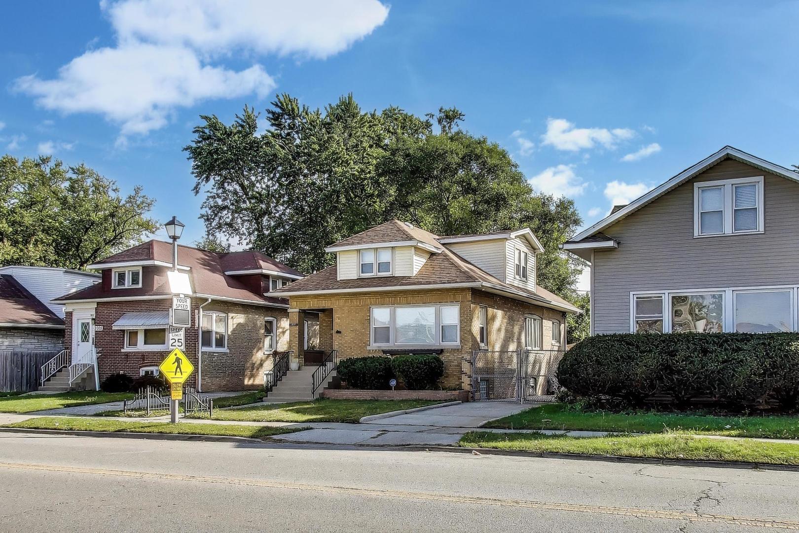 2007 South 9th Avenue Maywood, IL 60153 - Photo 2 of 37 a view of a brick house with a yard garden and plants