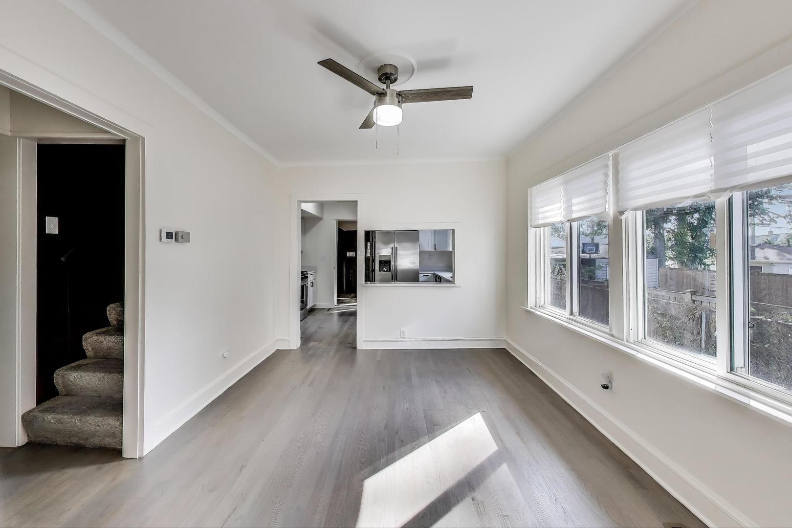 2007 South 9th Avenue Maywood, IL 60153 - Photo 6 of 37 a view of an empty room with a window and wooden floor