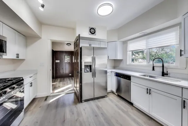 a kitchen with a refrigerator and a sink