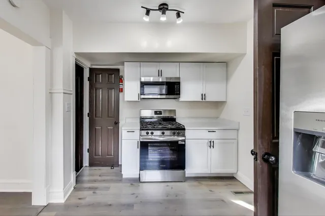 a kitchen with a stove and a refrigerator