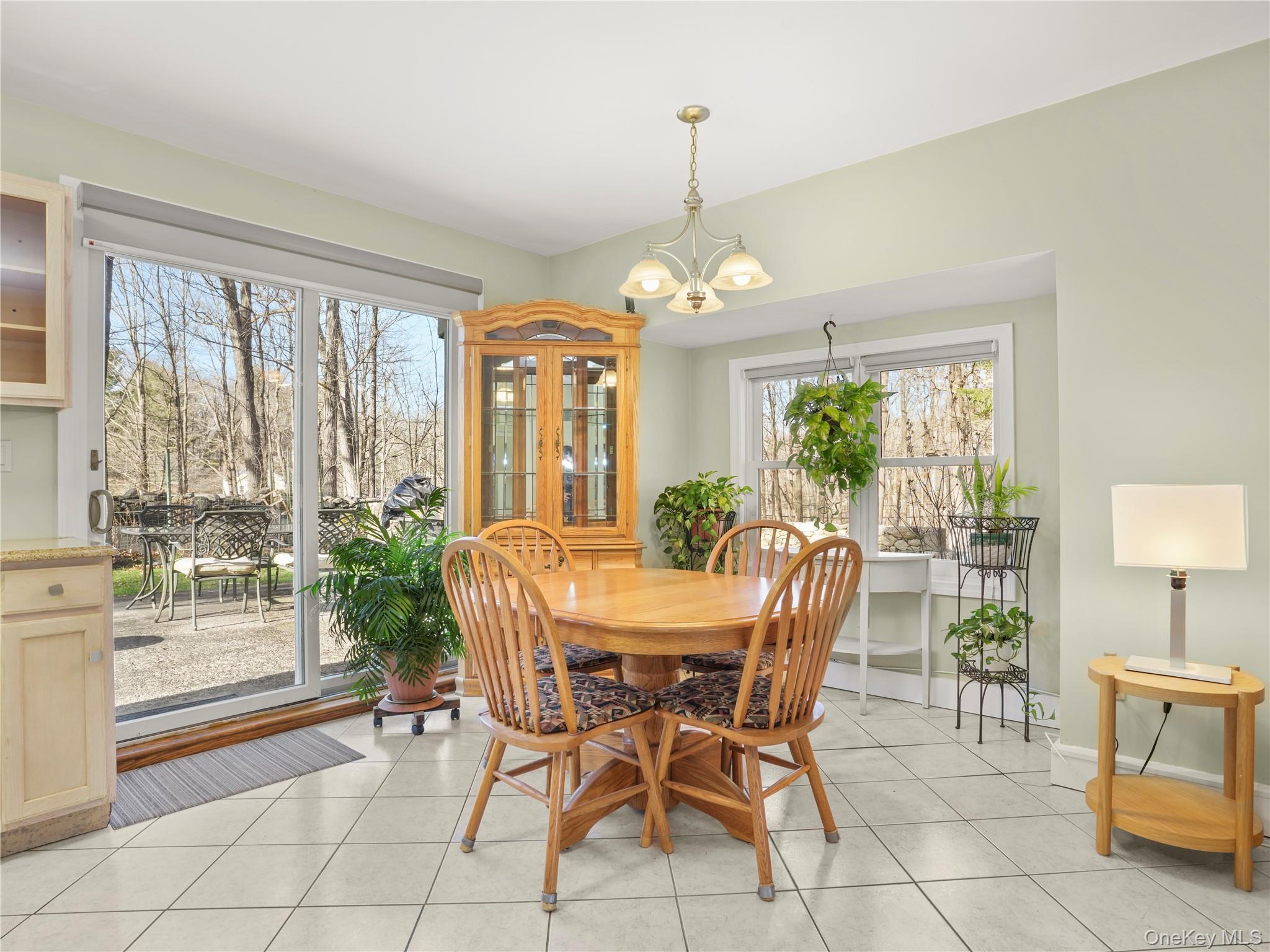 290 Salem Road Pound Ridge, NY 10576 - Photo 17 of 21 a view of a dining room with furniture large windows and wooden floor