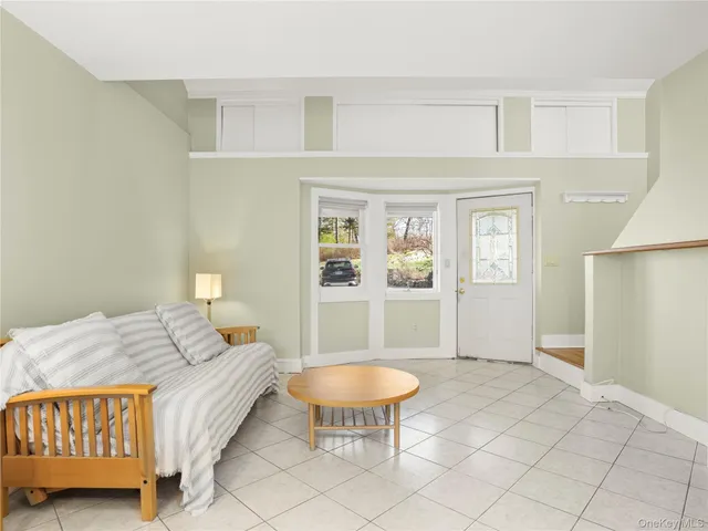 a bedroom with a bed a table and chair