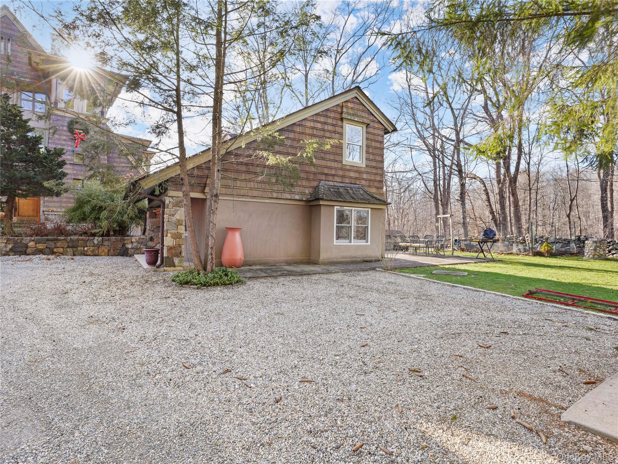290 Salem Road Pound Ridge, NY 10576 - Photo 2 of 21 a view of a house with a yard and garage