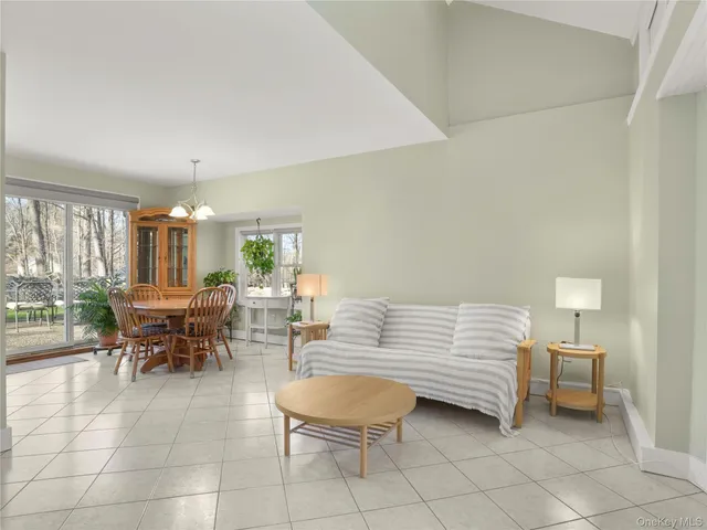 a living room with furniture a dining table and a piano table