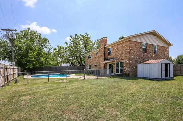 a view of a house with swimming pool and a yard