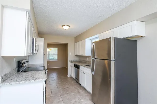 a kitchen with a refrigerator a sink and a stove