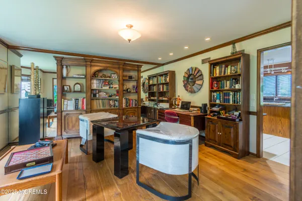 a room with pool table and windows