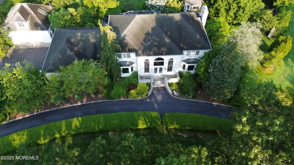 an aerial view of house with yard swimming pool and outdoor seating