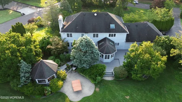 an aerial view of a house with garden space and street view