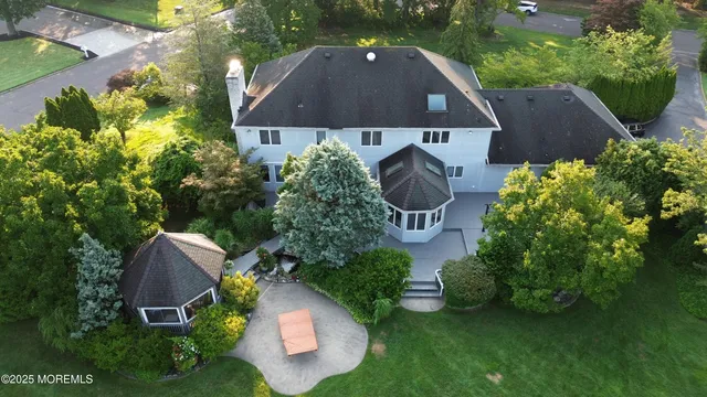 an aerial view of a house with garden space and street view
