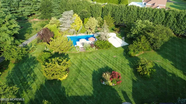 a backyard of a house with fountain table and chairs