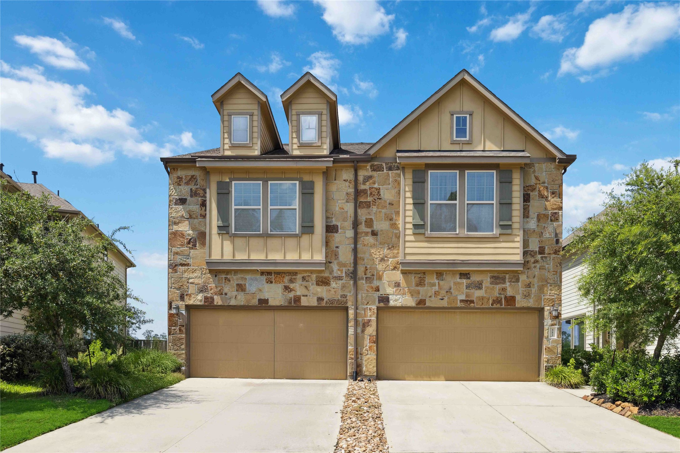 Beautiful brick and stone exterior with landscaped entry and 2-car garage.