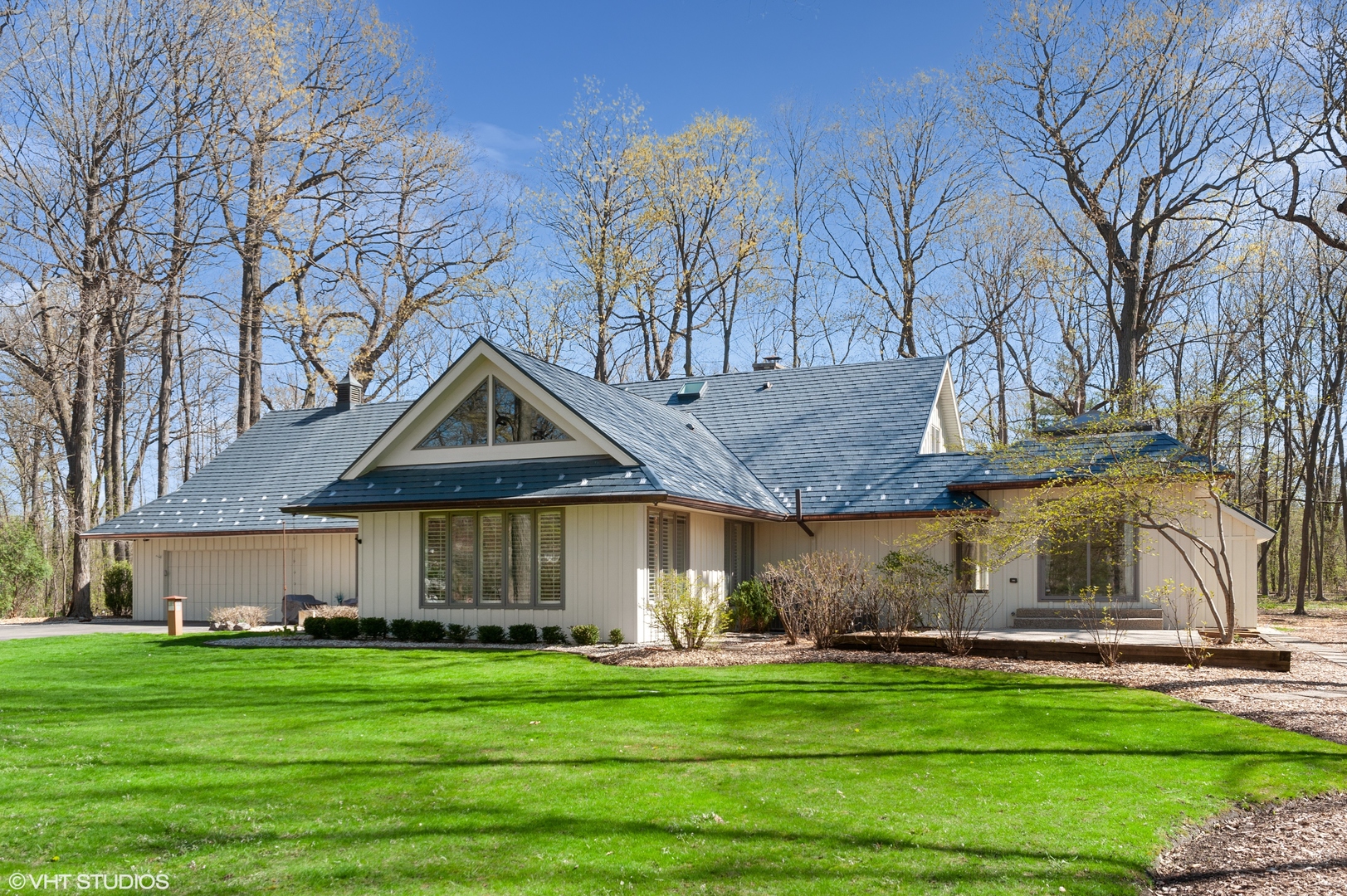 1685 Millburne Road Lake Forest, IL 60045 - Photo 1 of 21 a front view of a house with a garden