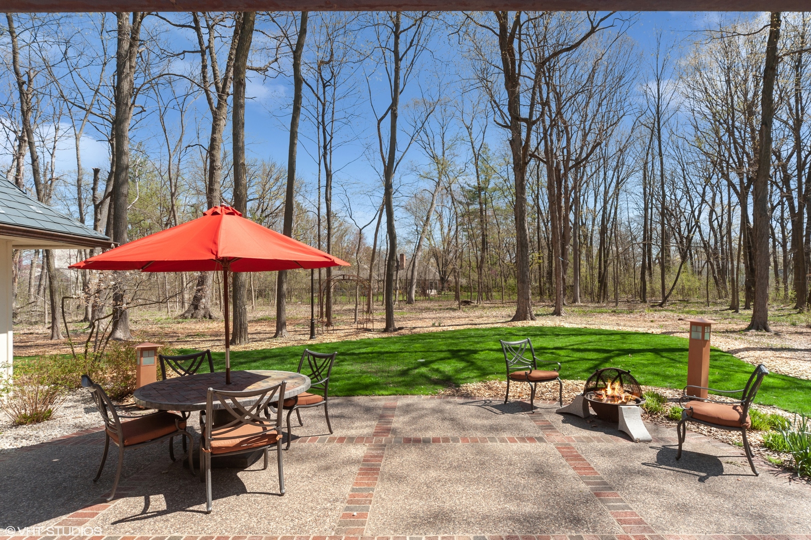1685 Millburne Road Lake Forest, IL 60045 - Photo 15 of 21 a view of a house with backyard sitting area and garden