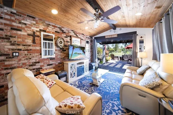a living room with furniture a fireplace and a chandelier