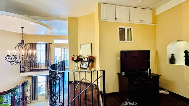a view of a room with wooden floor and windows
