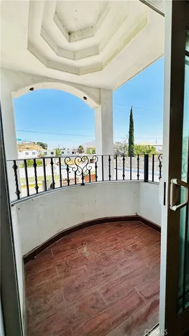 a view of a balcony with wooden floor