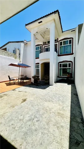 a view of a house with a barbeque and wooden floor