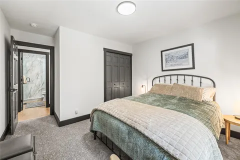a bedroom with a bed and a painting on the wall