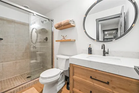 a bathroom with a sink a toilet and a mirror