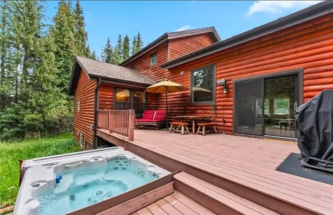a view of house with backyard and sitting area