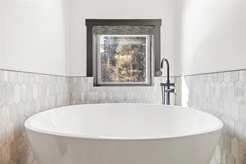 a white bath tub sitting in a bathroom