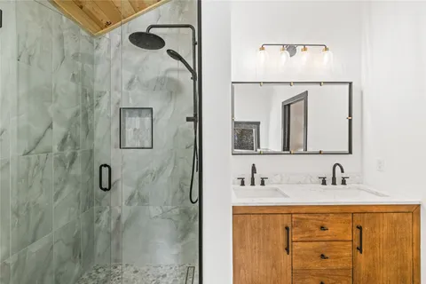 a bathroom with a sink vanity and mirror