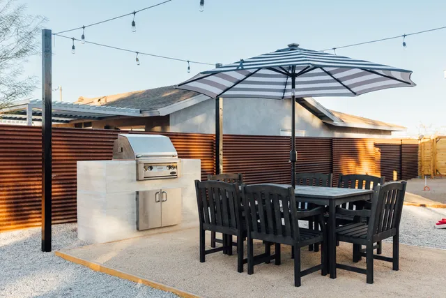 a patio with a table and chairs