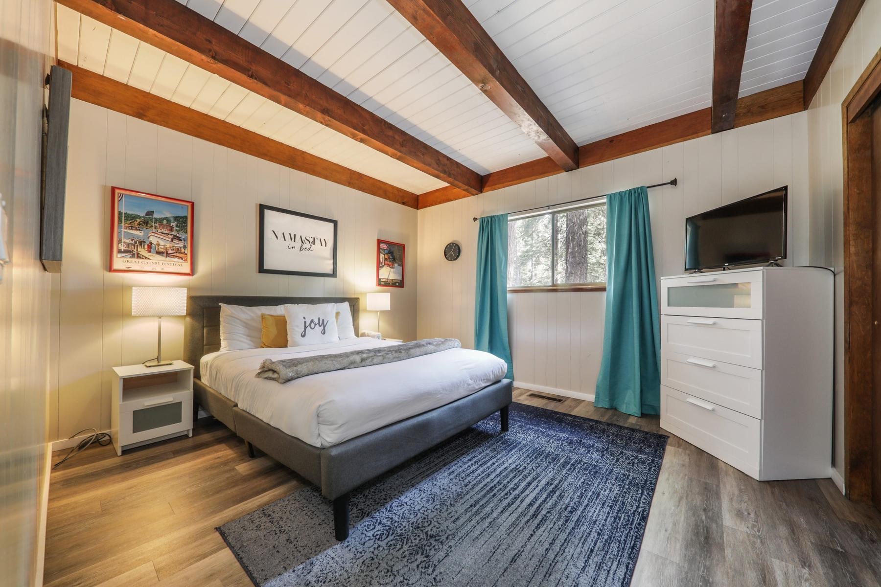 5656 Victoria Road Carnelian Bay, CA 96140 - Photo 17 of 28 a bedroom with a bed and a flat screen tv