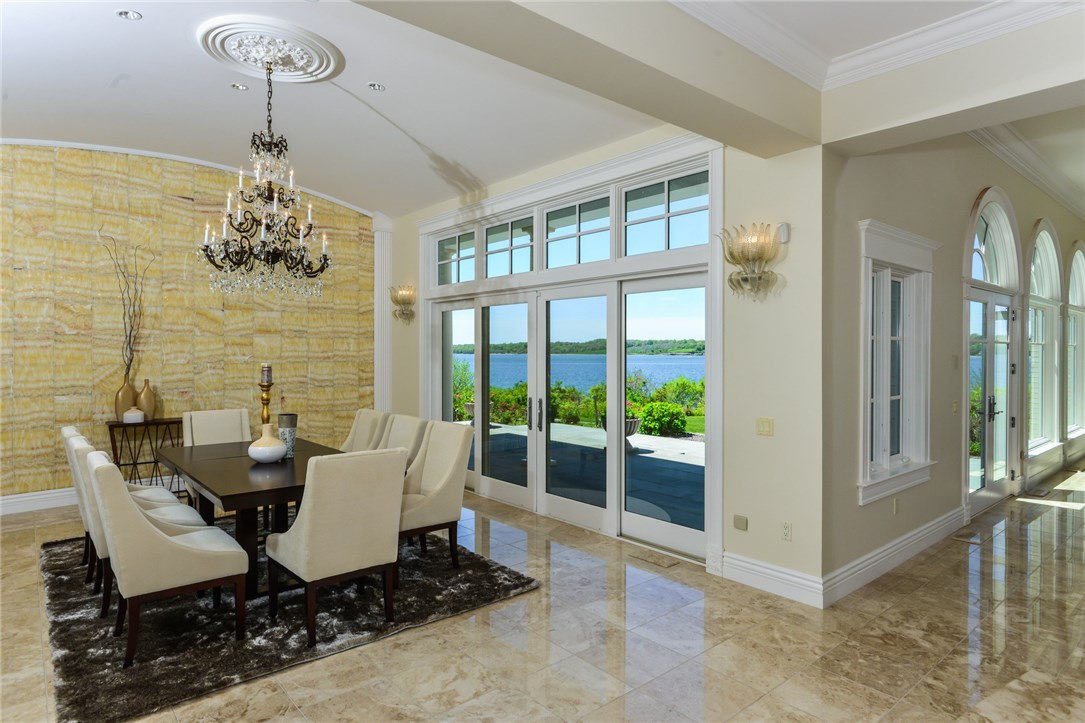 137 High Hill Road Tiverton, RI 02878 - Photo 11 of 39 The curved wall made of French onyx opens onto the waterfront terrace.